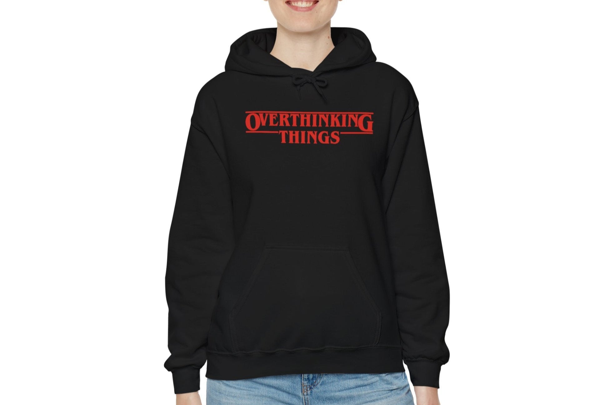Model wearing a black hoodie featuring the text "Overthinking Things" in the iconic Stranger Things font and style. Part of the Vivid Divergence Sensory Friendly Unisex Hoodie Range.