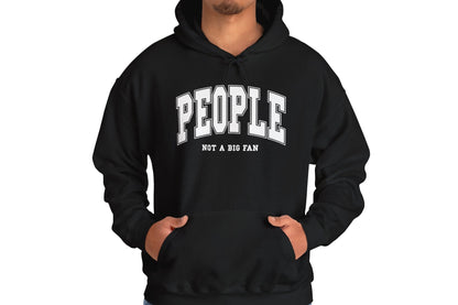 Model wearing a black hoodie featuring the text "People, Not a Big Fan" in bold collegiate-style white lettering. Part of the Vivid Divergence Sensory Friendly Unisex Hoodie Range.