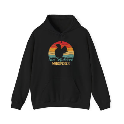 Front view of a black hoodie featuring the text "Squirrel Whisperer" with an ADHD mascot design of a squirrel and a retro sunset background. Part of the Vivid Divergence Sensory Friendly Unisex Hoodie Range.