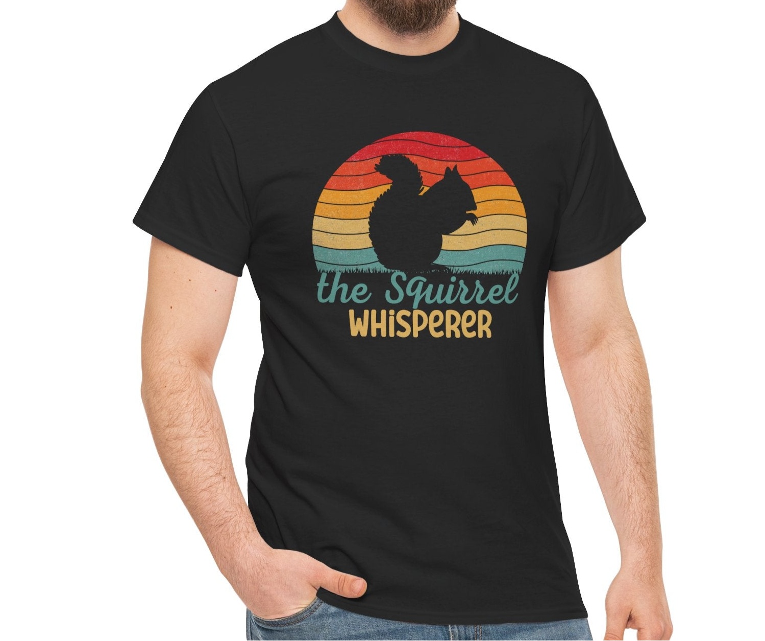Model wearing a black T-shirt with "The Squirrel Whisperer" and a silhouette of a squirrel against a retro sunset design. Part of the Vivid Divergence Sensory Friendly Unisex Tees Range.