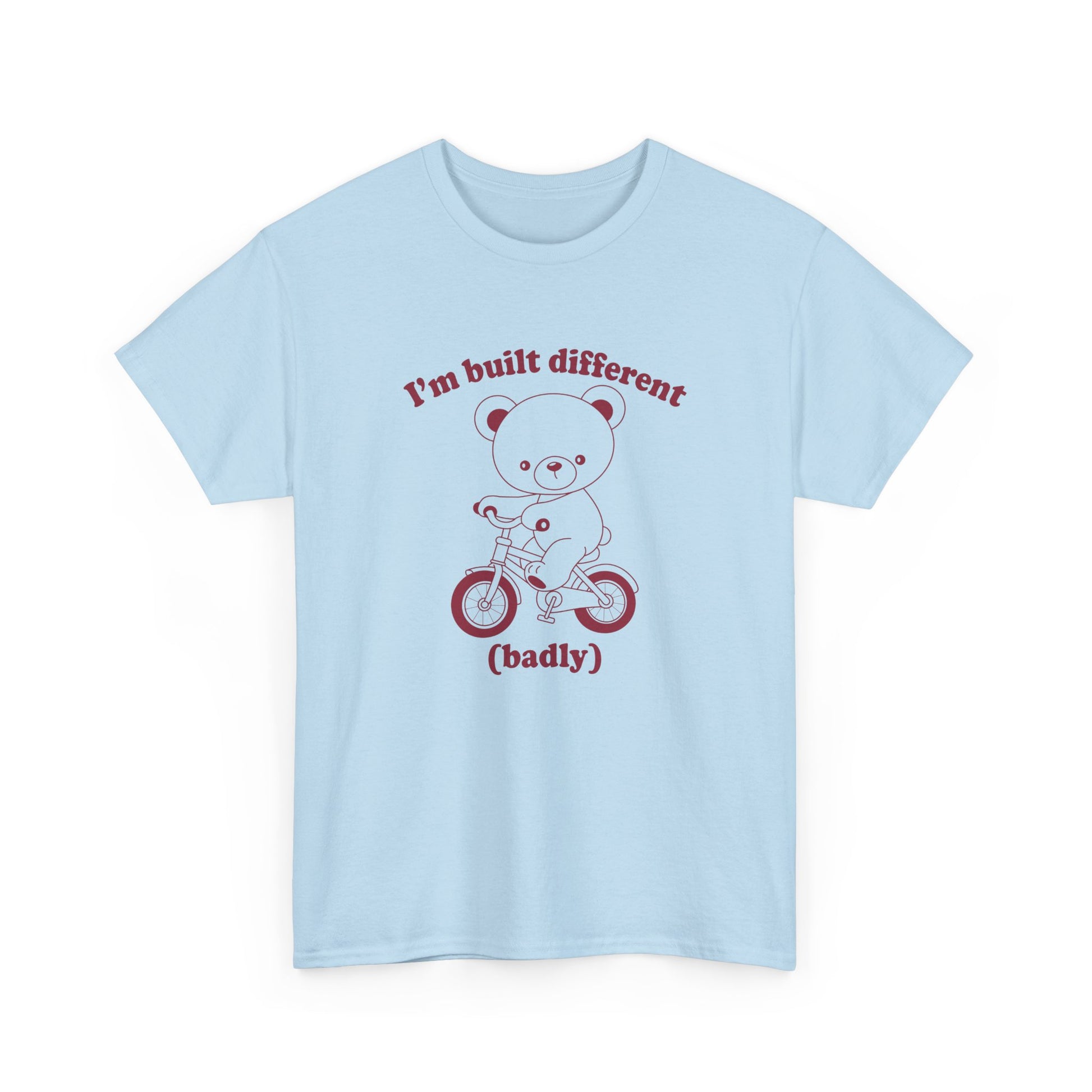 Front view of a blue T-shirt featuring the "Built Different (Badly)" bear design. Part of the Vivid Divergence Sensory Friendly Unisex Tees Range.