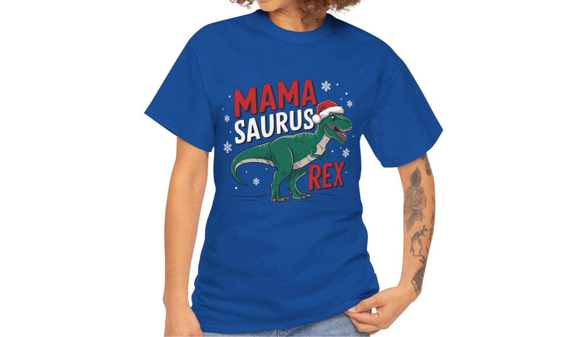 Model wearing a blue T-shirt featuring a "Mama-Saurus Rex" design with a festive dinosaur illustration, styled casually. Part of the Vivid Divergence Sensory Friendly Unisex Tees Range.