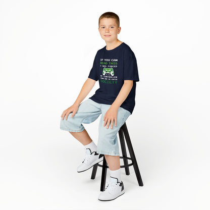 Boy sitting on a stool wearing a navy blue "Forced to Put My Controller Down" kids T-shirt with a green game controller graphic and humorous text. Part of the Vivid Divergence Sensory Friendly Kids Shirts Range. The perfect T-shirt for sensory-sensitive kids and comes with a Sensory Satisfaction Promise.
