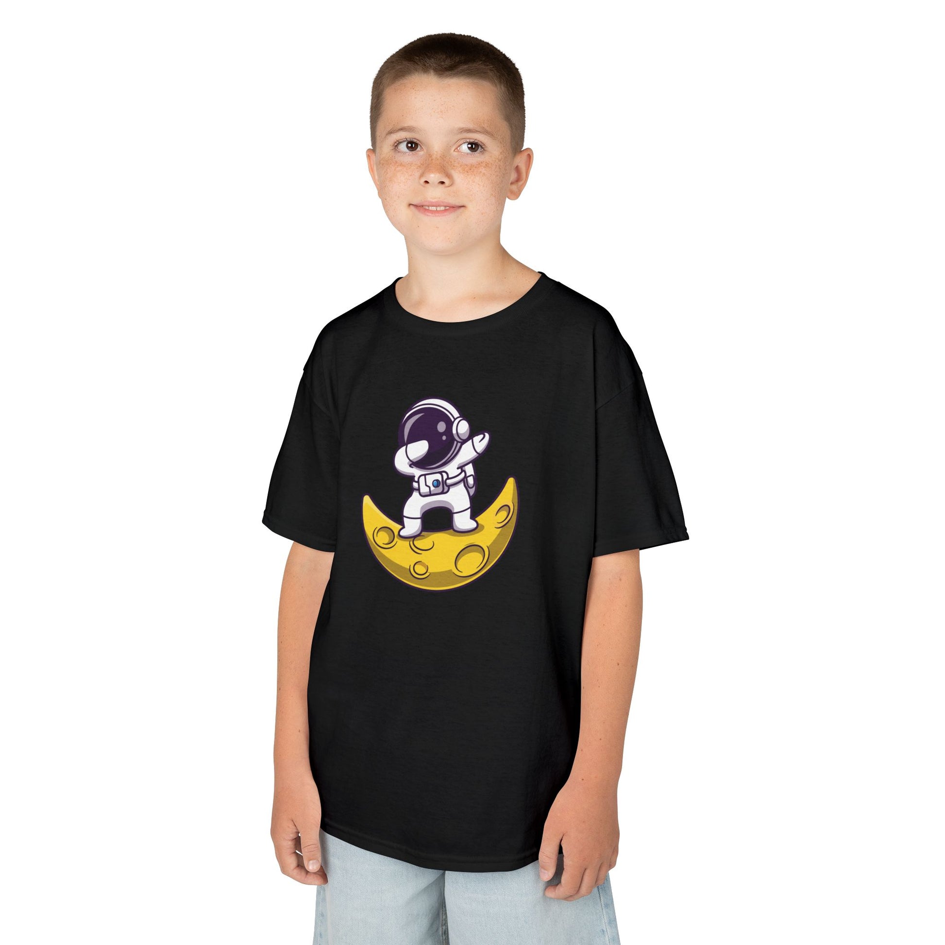 Boy wearing a black "Dabbing Astronaut on the Moon" kids T-shirt with an astronaut dabbing while sitting on a crescent moon. Part of the Vivid Divergence Sensory Friendly Kids Shirts Range. The perfect T-shirt for sensory-sensitive kids and comes with a Sensory Satisfaction Promise.