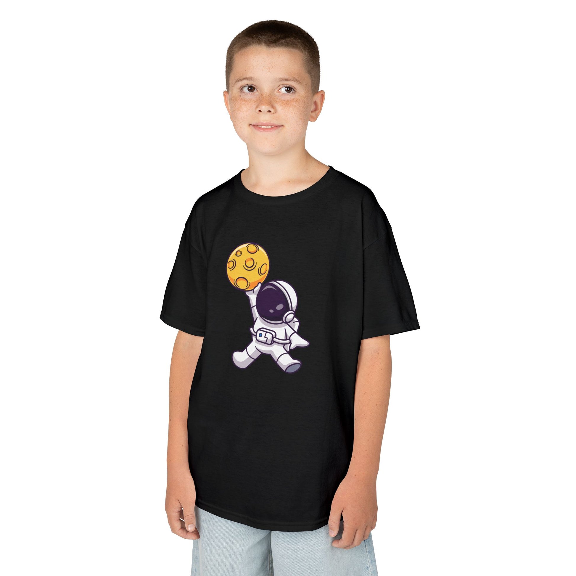 Boy wearing a black "Dunking Astronaut" space basketball kids T-shirt with an astronaut dunking a planet-like basketball. Part of the Vivid Divergence Sensory Friendly Kids Shirts Range. The perfect T-shirt for sensory-sensitive kids and comes with a Sensory Satisfaction Promise.