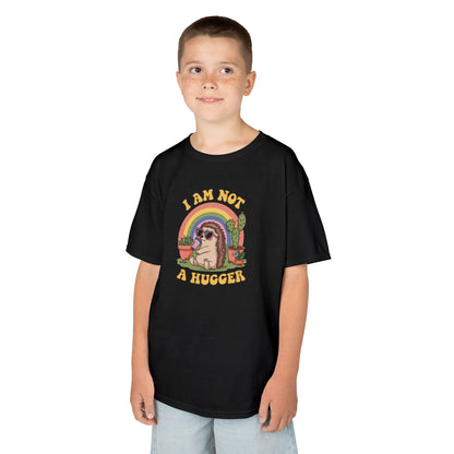Boy wearing a black "I Am Not A Hugger" kids T-shirt with a cute cactus graphic and rainbow background. Part of the Vivid Divergence Sensory Friendly Kids Shirts Range. The perfect T-shirt for sensory-sensitive kids and comes with a Sensory Satisfaction Promise.