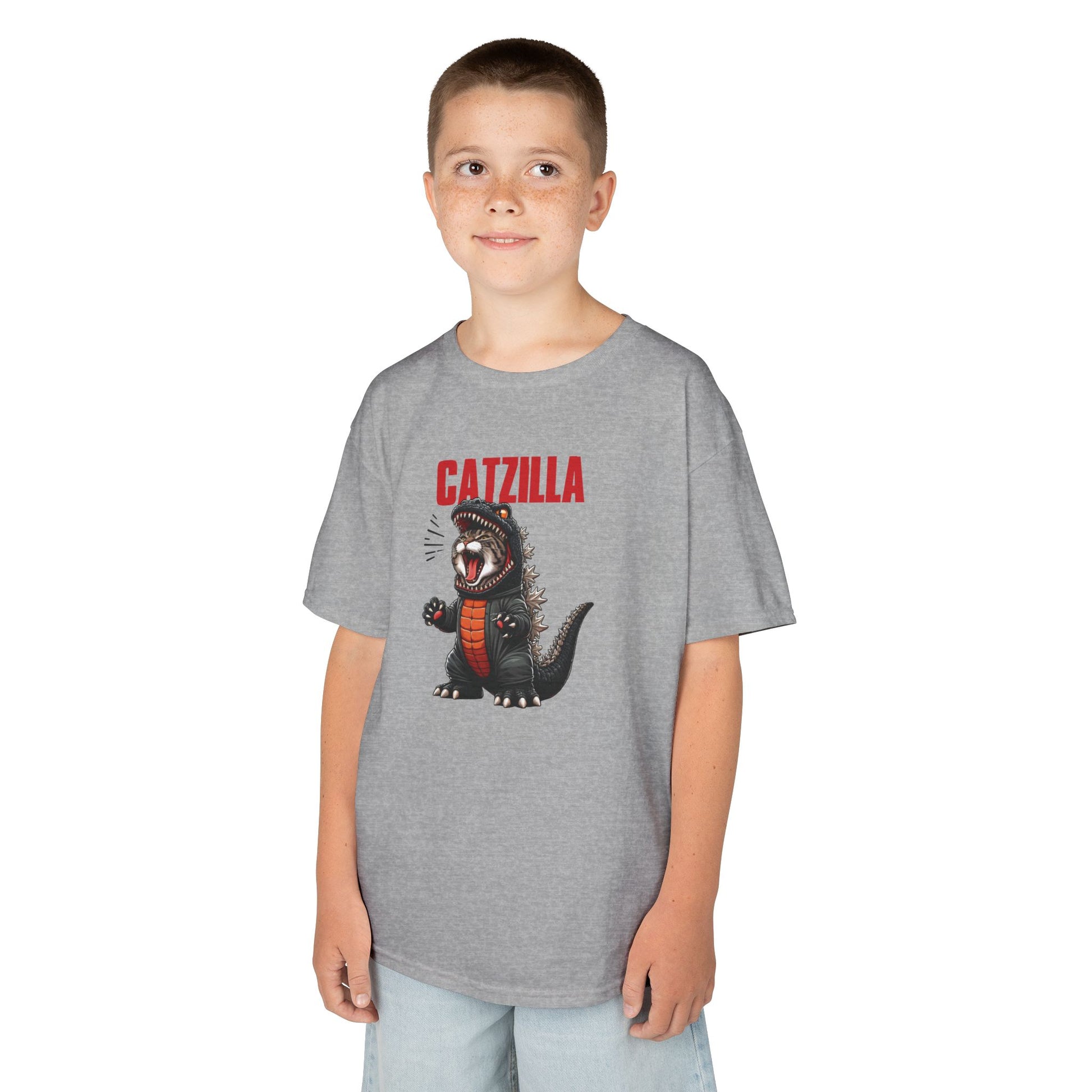  Boy wearing a gray "Catzilla" Godzilla parody kids T-shirt with a cartoon cat designed like Godzilla. Part of the Vivid Divergence Sensory Friendly Kids Shirts Range. The perfect T-shirt for sensory-sensitive kids and comes with a Sensory Satisfaction Promise.