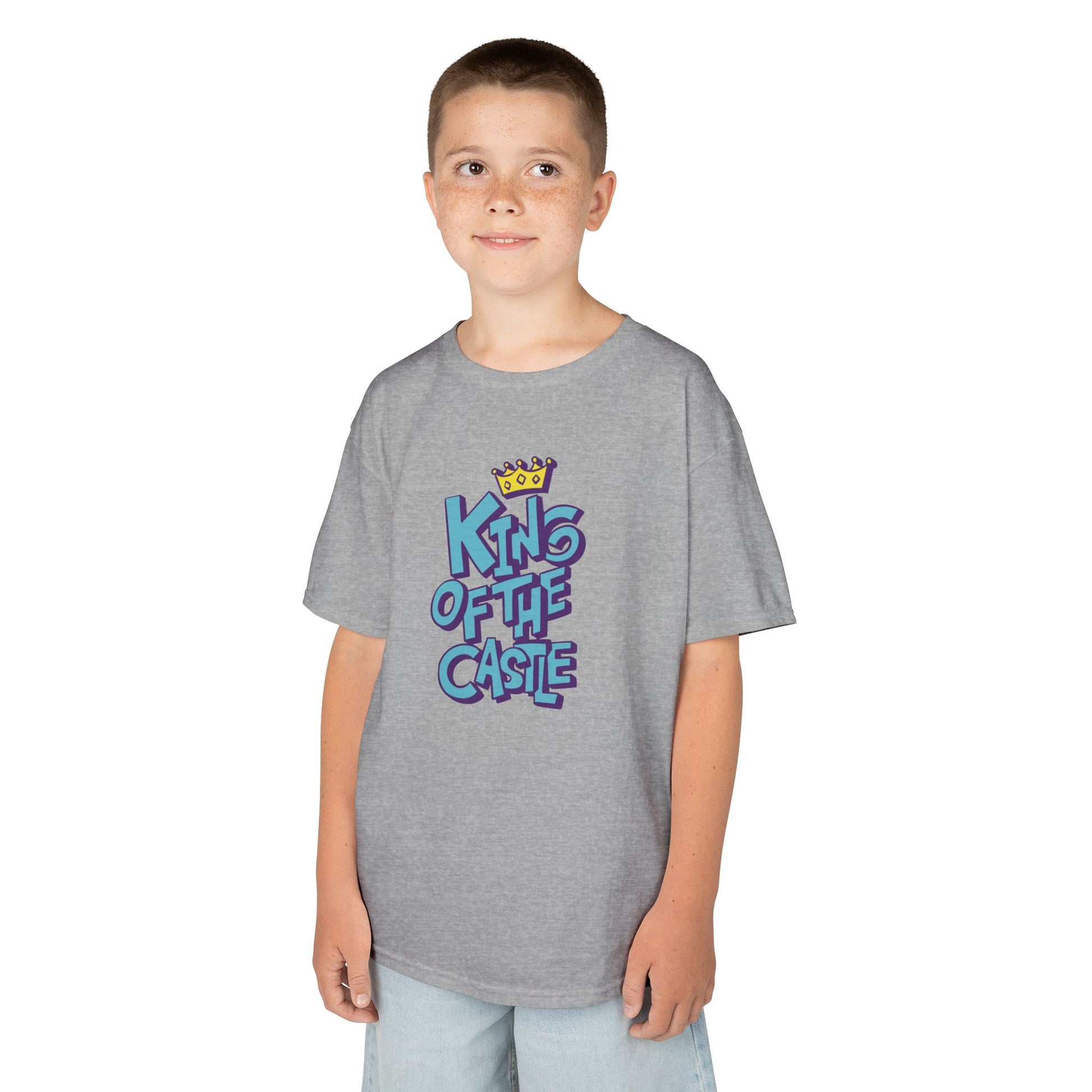 Boy wearing a gray "King Of The Castle" kids T-shirt with bold blue text and a crown graphic. Part of the Vivid Divergence Sensory Friendly Kids Shirts Range. The perfect T-shirt for sensory-sensitive kids and comes with a Sensory Satisfaction Promise.