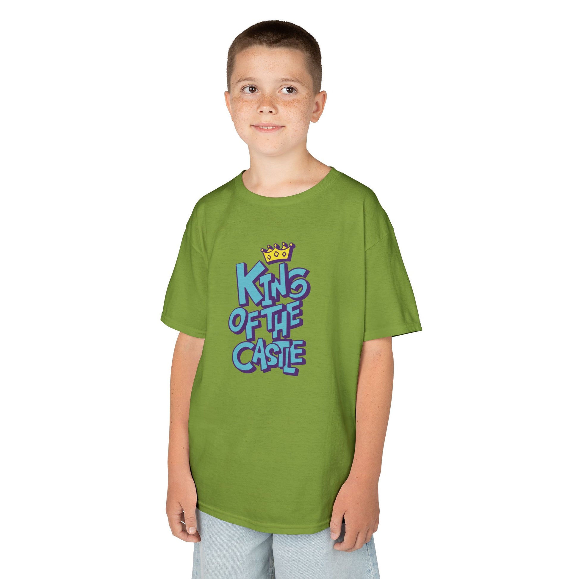 Boy wearing a green "King Of The Castle" kids T-shirt with bold blue text and a crown graphic. Part of the Vivid Divergence Sensory Friendly Kids Shirts Range. The perfect T-shirt for sensory-sensitive kids and comes with a Sensory Satisfaction Promise.