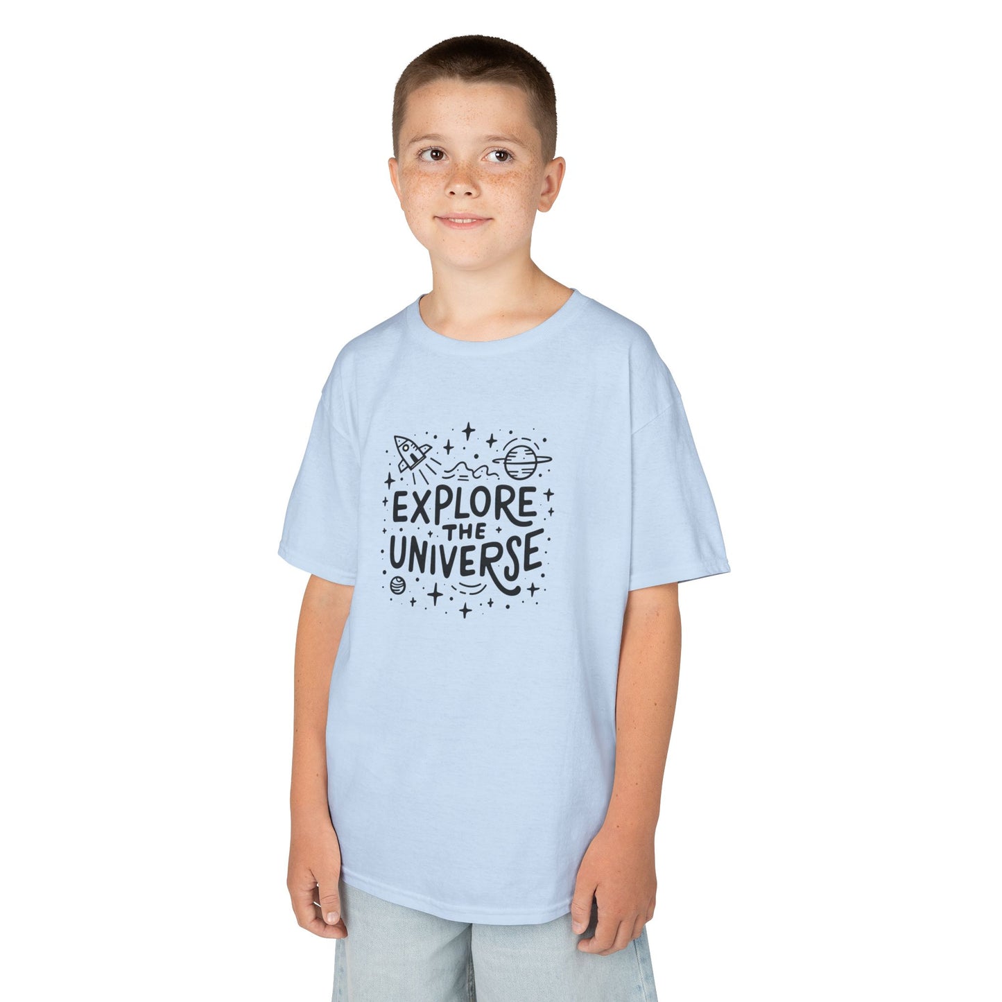 Boy wearing a light blue "Explore The Universe" kids T-shirt with a space-themed graphic. Part of the Vivid Divergence Sensory Friendly Kids Shirts Range. The perfect T-shirt for sensory-sensitive kids and comes with a Sensory Satisfaction Promise.