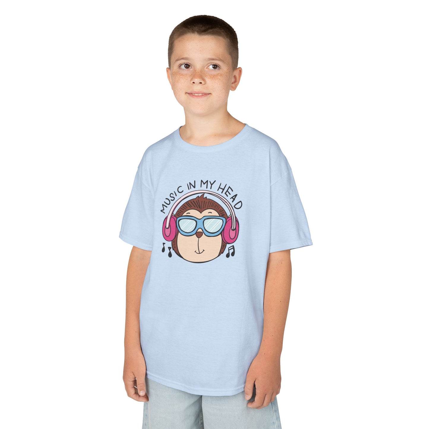 Boy wearing a light blue "Music In My Head" monkey kids T-shirt with a cartoon monkey wearing headphones. Part of the Vivid Divergence Sensory Friendly Kids Shirts Range. The perfect T-shirt for sensory-sensitive kids and comes with a Sensory Satisfaction Promise.