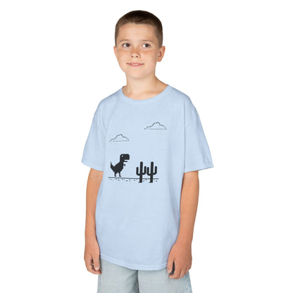 Boy wearing a light blue "T-Rex Runner" Dinosaur Game kids T-shirt with a pixelated T-Rex and cactus design. Part of the Vivid Divergence Sensory Friendly Kids Shirts Range. The perfect T-shirt for sensory-sensitive kids and comes with a Sensory Satisfaction Promise.