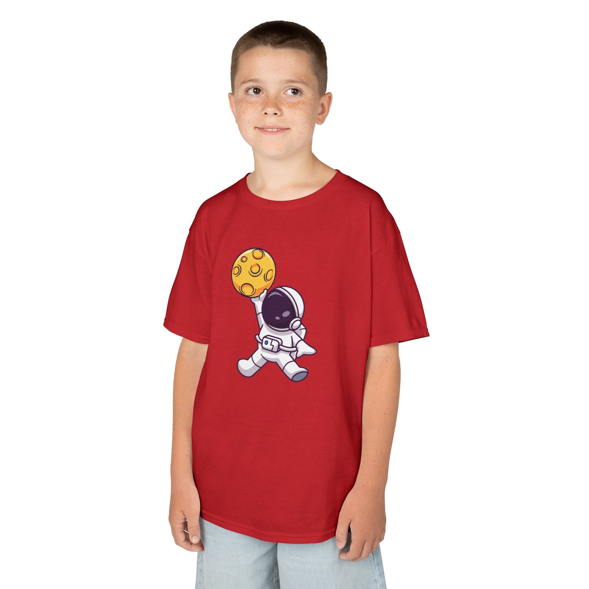 Boy wearing a red "Dunking Astronaut" space basketball kids T-shirt with an astronaut dunking a planet-like basketball. Part of the Vivid Divergence Sensory Friendly Kids Shirts Range. The perfect T-shirt for sensory-sensitive kids and comes with a Sensory Satisfaction Promise.