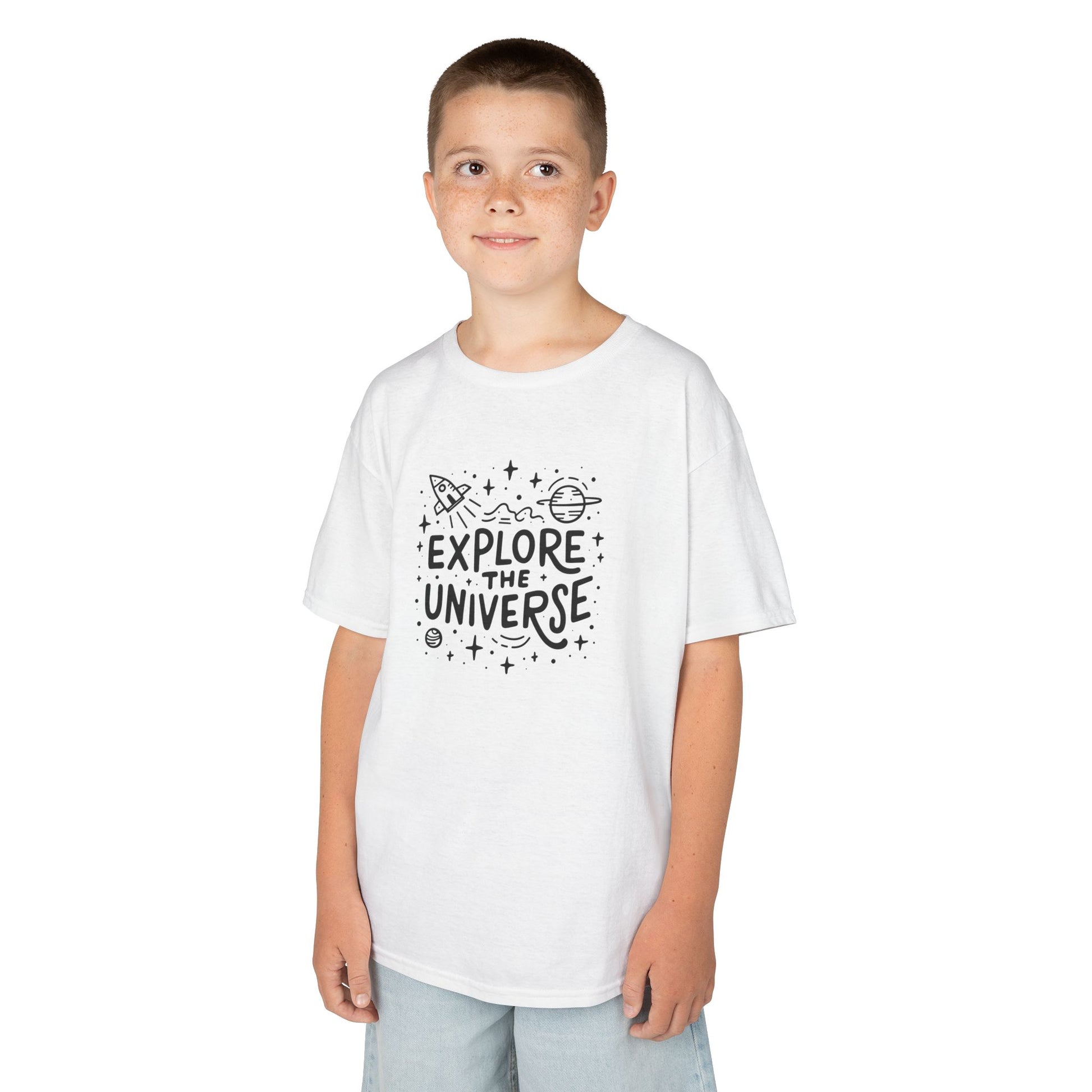 Boy wearing a white "Explore The Universe" kids T-shirt with a space-themed graphic. Part of the Vivid Divergence Sensory Friendly Kids Shirts Range. The perfect T-shirt for sensory-sensitive kids and comes with a Sensory Satisfaction Promise.