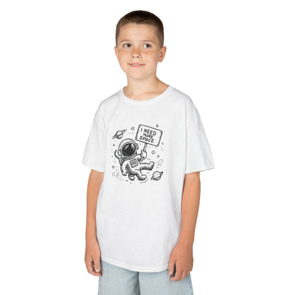 Boy wearing a white "I Need More Space" astronaut kids T-shirt with a cartoon astronaut floating among space icons. Part of the Vivid Divergence Sensory Friendly Kids Shirts Range. The perfect T-shirt for sensory-sensitive kids and comes with a Sensory Satisfaction Promise.