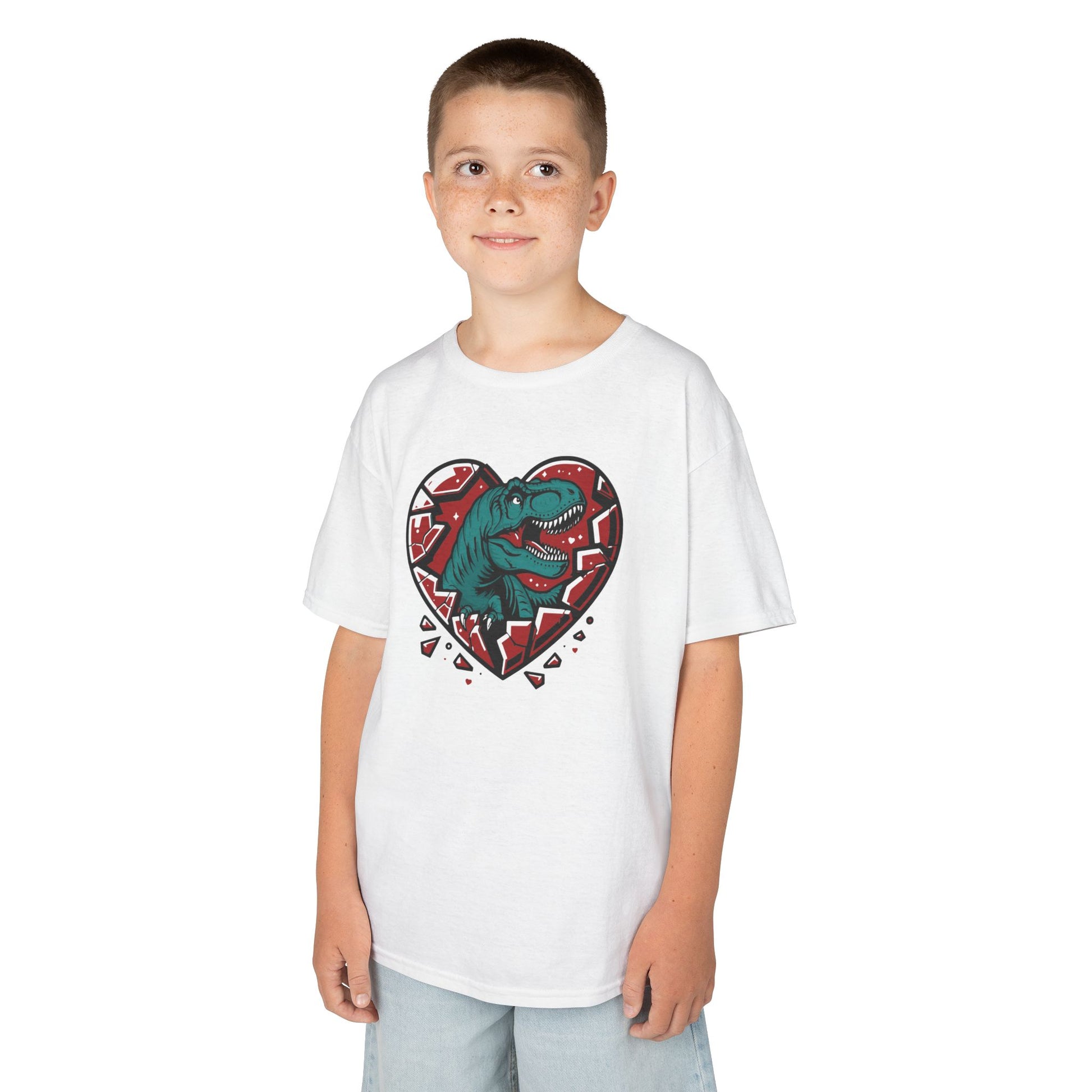 Boy wearing a white "Jurassic Heart" kids T-shirt with a dinosaur inside a heart graphic. Part of the Vivid Divergence Sensory Friendly Kids Shirts Range. The perfect T-shirt for sensory-sensitive kids and comes with a Sensory Satisfaction Promise.