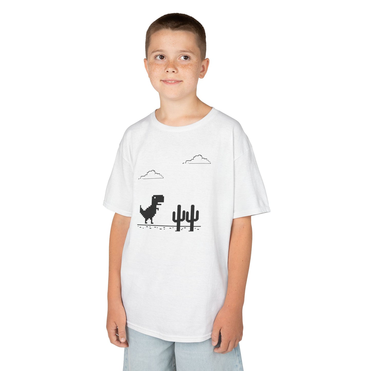 Boy wearing a white "T-Rex Runner" Dinosaur Game kids T-shirt with a pixelated T-Rex and cactus design. Part of the Vivid Divergence Sensory Friendly Kids Shirts Range. The perfect T-shirt for sensory-sensitive kids and comes with a Sensory Satisfaction Promise.
