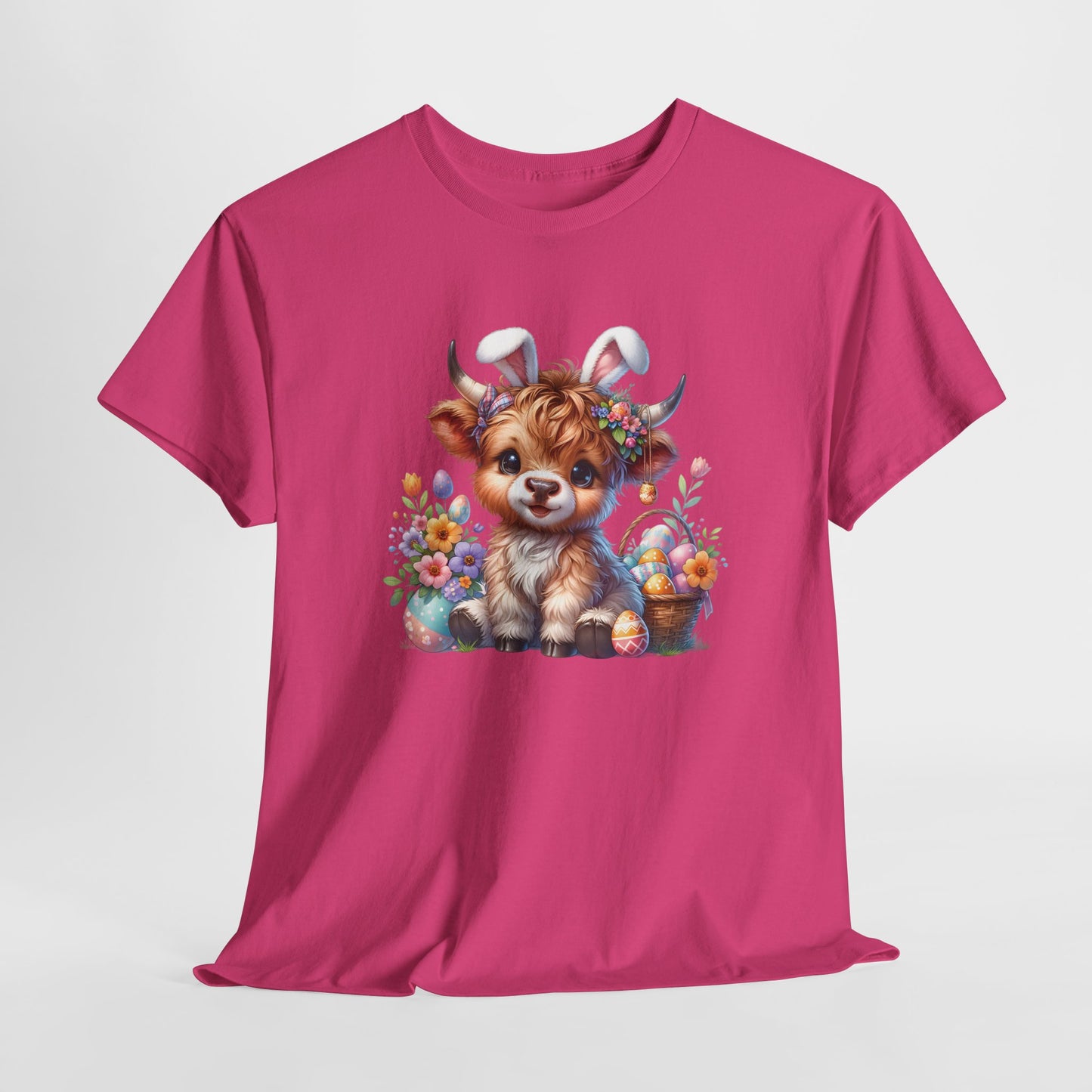 Bright pink T-shirt hanging, featuring an adorable Highland cow dressed for Easter, blending country charm with festive spirit. Hop into the season in style and shop Easter shirts online today!