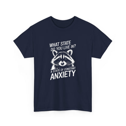 Front view of a navy blue T-shirt with a white raccoon graphic and the text "What state do you live in? A constant state of chronic anxiety." Part of the Vivid Divergence Sensory Friendly Unisex Tees Range.
