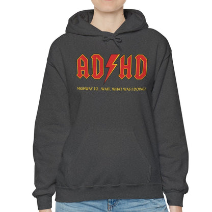 Model wearing a dark gray hoodie with the text "ADHD" in AC/DC parody style bold orange lettering and "Highway to Hey, What Was I Doing?" underneath. Part of the Vivid Divergence Sensory Friendly Unisex Hoodie Range.