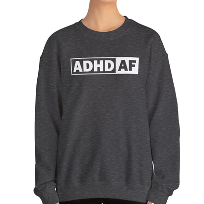Model wearing dark grey sweater jumper with "ADHD AF" text in bold white lettering. Part of the Vivid Divergence Sensory Friendly Unisex Sweater Jumper Range. 