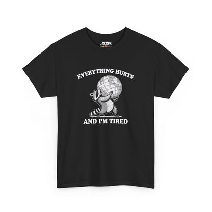 Front view of black T-shirt featuring a vintage style sketch of a raccoon carrying the world with the phrase “Everything Hurts and I’m Tired.” The official uniform of burnt out. Part of the Vivid Divergence Memewear Collection!