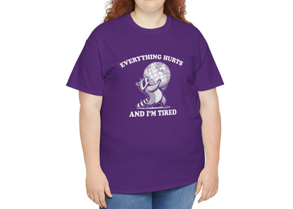 Modeled view of purple T-shirt featuring a vintage style sketch of a raccoon carrying the world with the phrase “Everything Hurts and I’m Tired.” The official uniform of burnt out. Part of the Vivid Divergence Memewear Collection!