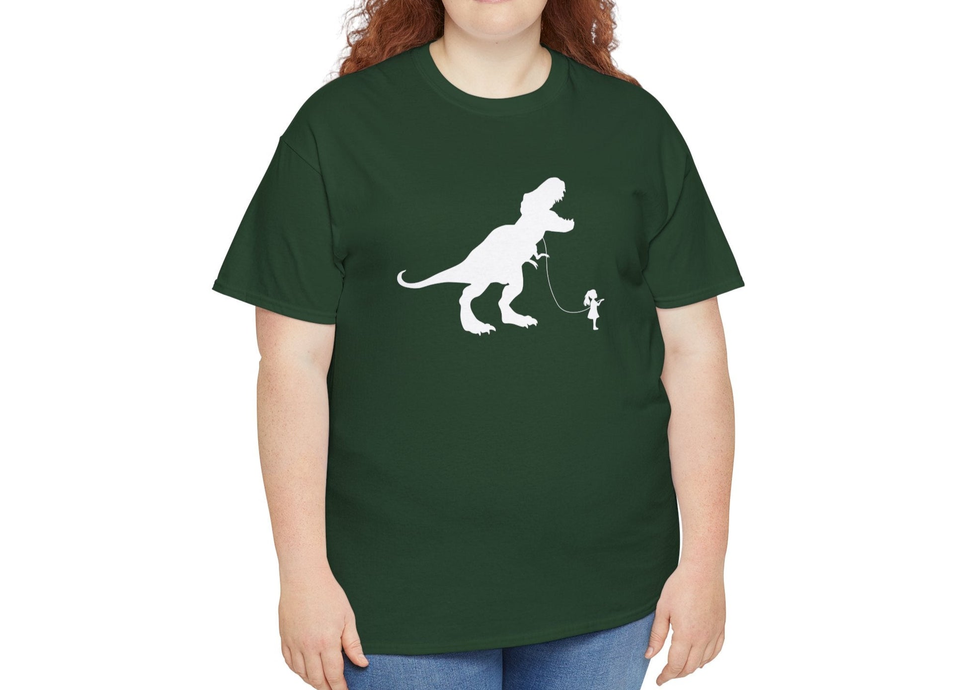 Model wearing a forest green T-shirt featuring a white silhouette of a girl walking a T-Rex on a leash. Part of the Vivid Divergence Sensory Friendly Unisex Tees Range.