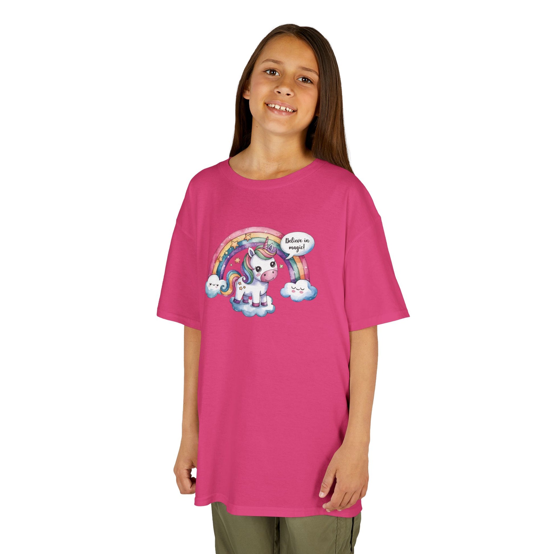 Girl wearing a hot pink "Believe In Magic" unicorn kids T-shirt with a colorful unicorn under a rainbow. Part of the Vivid Divergence Sensory Friendly Kids Shirts Range. The perfect T-shirt for sensory-sensitive kids and comes with a Sensory Satisfaction Promise.