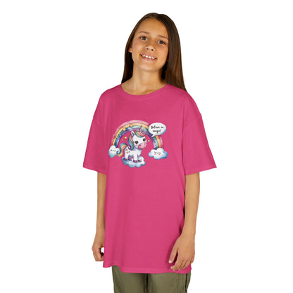 Girl wearing a hot pink "Believe In Magic" unicorn kids T-shirt with a colorful unicorn under a rainbow. Part of the Vivid Divergence Sensory Friendly Kids Shirts Range. The perfect T-shirt for sensory-sensitive kids and comes with a Sensory Satisfaction Promise.