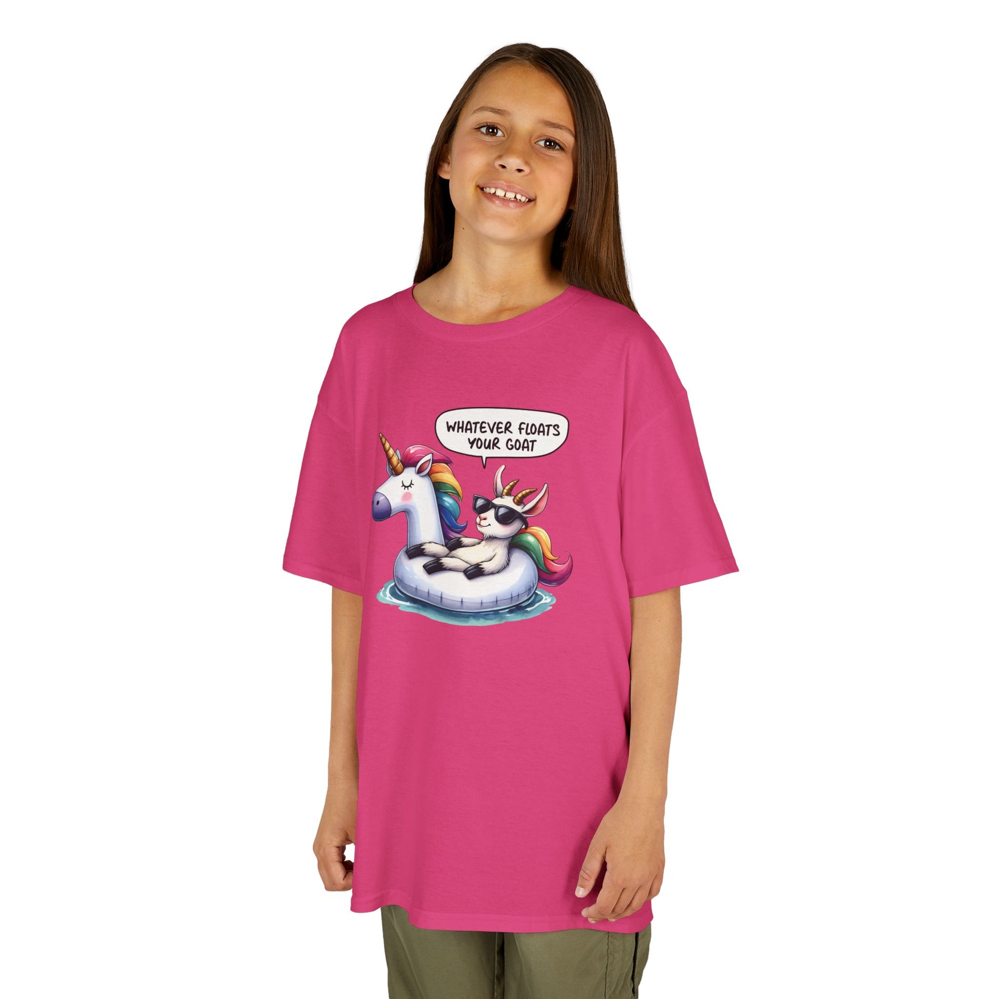 Girl wearing a hot pink "Whatever Floats Your Goat" kids T-shirt with a cartoon goat floating on a unicorn pool float. Part of the Vivid Divergence Sensory Friendly Kids Shirts Range. The perfect T-shirt for sensory-sensitive kids and comes with a Sensory Satisfaction Promise.