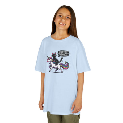 Girl wearing a light blue "Giddy Up, There's Chaos to Spread" cat and unicorn kids T-shirt with a playful graphic. Part of the Vivid Divergence Sensory Friendly Kids Shirts Range. The perfect T-shirt for sensory-sensitive kids and comes with a Sensory Satisfaction Promise.