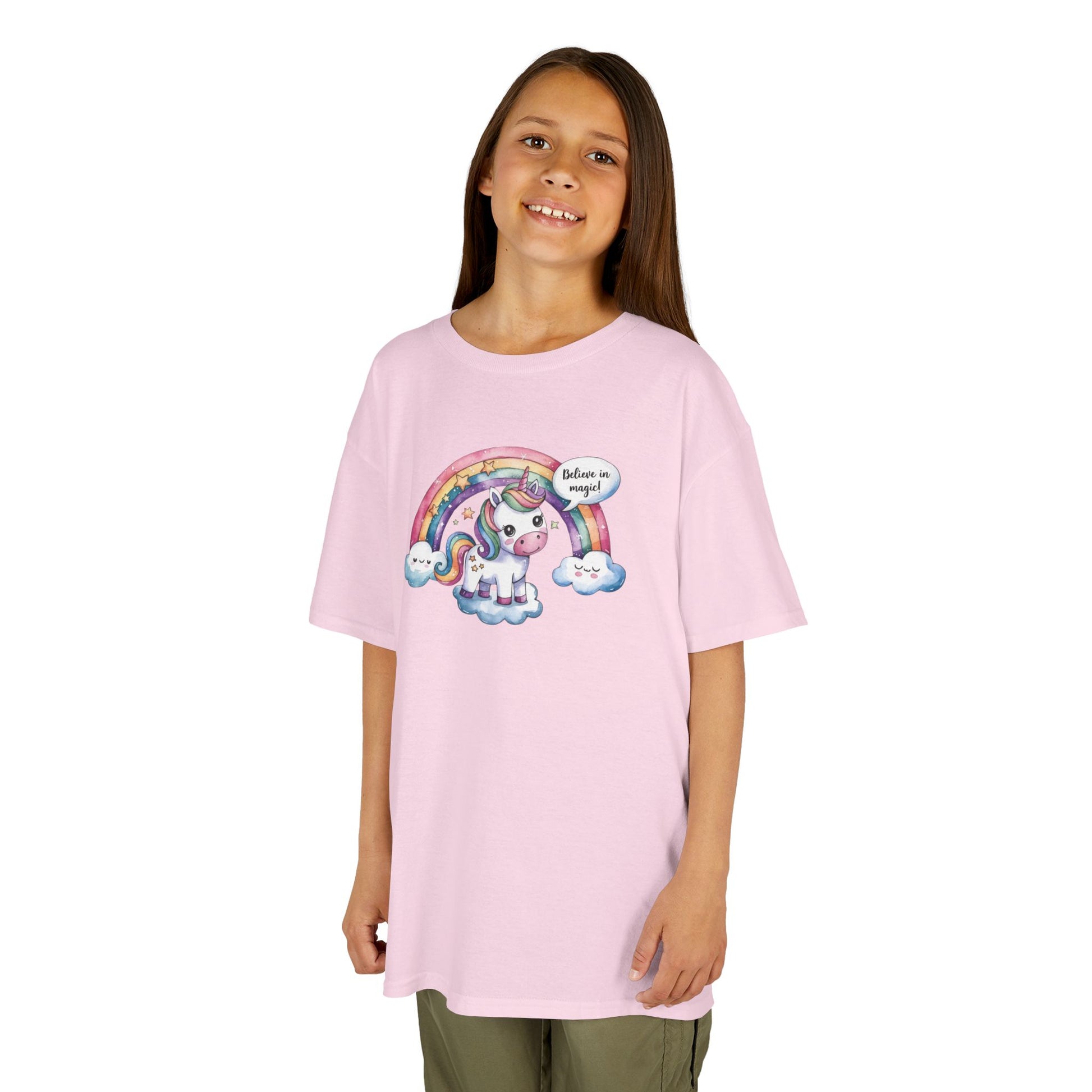 Girl wearing a pink "Believe In Magic" unicorn kids T-shirt with a colorful unicorn under a rainbow. Part of the Vivid Divergence Sensory Friendly Kids Shirts Range. The perfect T-shirt for sensory-sensitive kids and comes with a Sensory Satisfaction Promise.