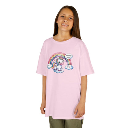 Girl wearing a pink "Believe In Magic" unicorn kids T-shirt with a colorful unicorn under a rainbow. Part of the Vivid Divergence Sensory Friendly Kids Shirts Range. The perfect T-shirt for sensory-sensitive kids and comes with a Sensory Satisfaction Promise.