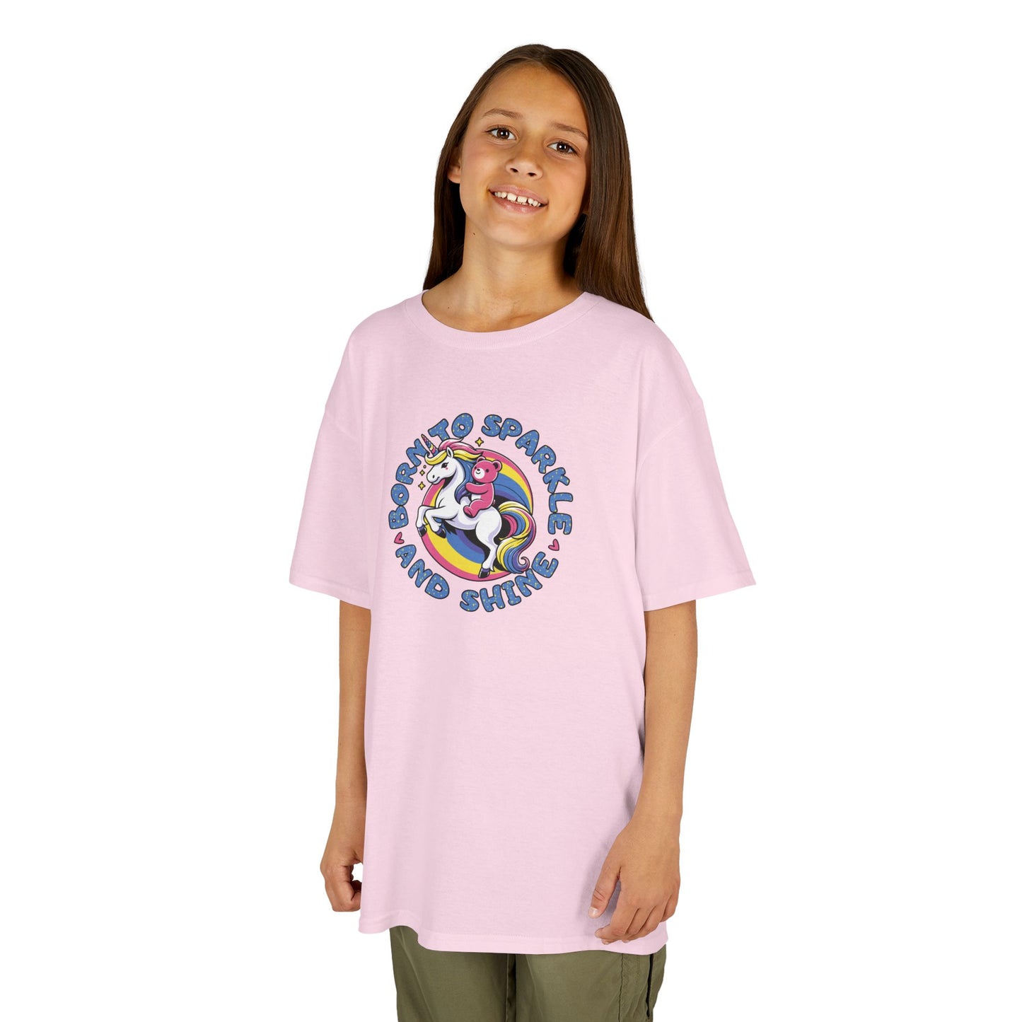 Girl wearing a pink "Born To Sparkle Shine" unicorn kids T-shirt with a colorful unicorn graphic. Part of the Vivid Divergence Sensory Friendly Kids Shirts Range. The perfect T-shirt for sensory-sensitive kids and comes with a Sensory Satisfaction Promise.