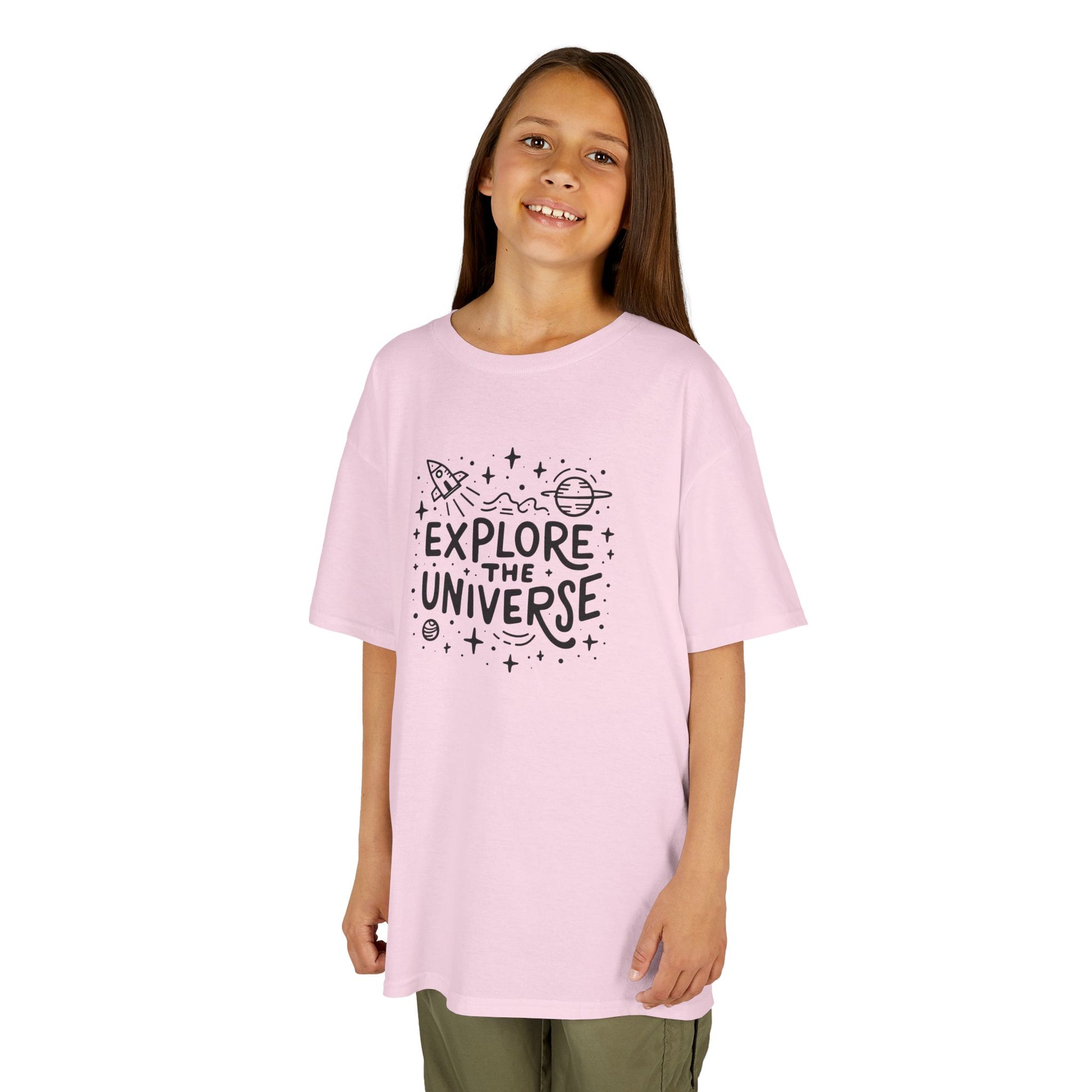 Girl wearing a pink "Explore The Universe" kids T-shirt with a space-themed graphic. Part of the Vivid Divergence Sensory Friendly Kids Shirts Range. The perfect T-shirt for sensory-sensitive kids and comes with a Sensory Satisfaction Promise.