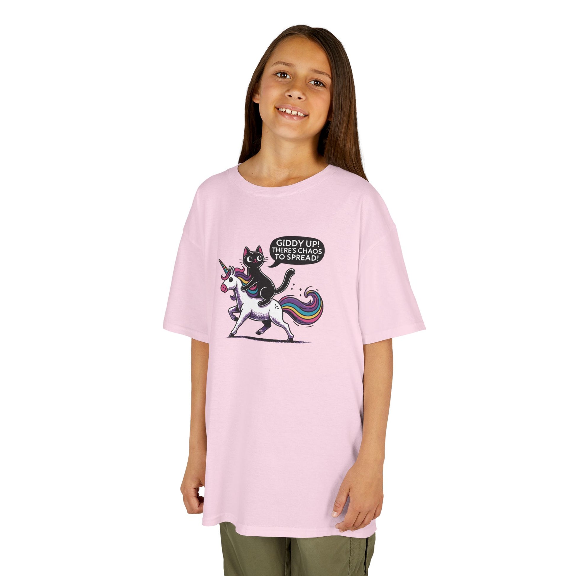 Girl wearing a pink "Giddy Up, There's Chaos to Spread" cat and unicorn kids T-shirt with a playful graphic. Part of the Vivid Divergence Sensory Friendly Kids Shirts Range. The perfect T-shirt for sensory-sensitive kids and comes with a Sensory Satisfaction Promise.