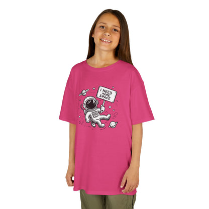 Girl wearing a pink "I Need More Space" astronaut kids T-shirt with a cartoon astronaut floating among space icons. Part of the Vivid Divergence Sensory Friendly Kids Shirts Range. The perfect T-shirt for sensory-sensitive kids and comes with a Sensory Satisfaction Promise.