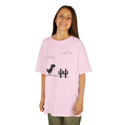 Girl wearing a pink "T-Rex Runner" Dinosaur Game kids T-shirt with a pixelated T-Rex and cactus design. Part of the Vivid Divergence Sensory Friendly Kids Shirts Range. The perfect T-shirt for sensory-sensitive kids and comes with a Sensory Satisfaction Promise.
