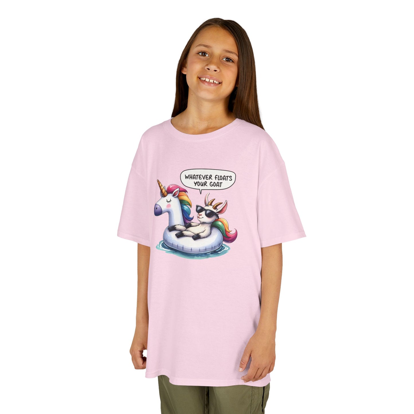 Girl wearing a pink "Whatever Floats Your Goat" kids T-shirt with a cartoon goat floating on a unicorn pool float. Part of the Vivid Divergence Sensory Friendly Kids Shirts Range. The perfect T-shirt for sensory-sensitive kids and comes with a Sensory Satisfaction Promise.
