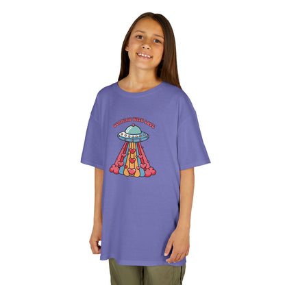 Girl wearing a purple "Beaming With Love" kids T-shirt with a colorful UFO beaming down hearts. Part of the Vivid Divergence Sensory Friendly Kids Shirts Range. The perfect T-shirt for sensory-sensitive kids and comes with a Sensory Satisfaction Promise.