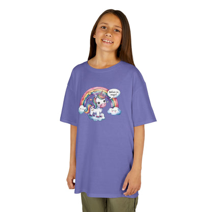 Girl wearing a purple "Believe In Magic" unicorn kids T-shirt with a colorful unicorn under a rainbow. Part of the Vivid Divergence Sensory Friendly Kids Shirts Range. The perfect T-shirt for sensory-sensitive kids and comes with a Sensory Satisfaction Promise.