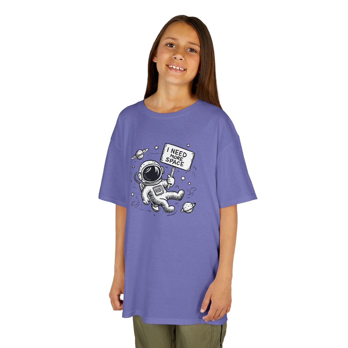 Girl wearing a purple "I Need More Space" astronaut kids T-shirt with a cartoon astronaut floating among space icons. Part of the Vivid Divergence Sensory Friendly Kids Shirts Range. The perfect T-shirt for sensory-sensitive kids and comes with a Sensory Satisfaction Promise.