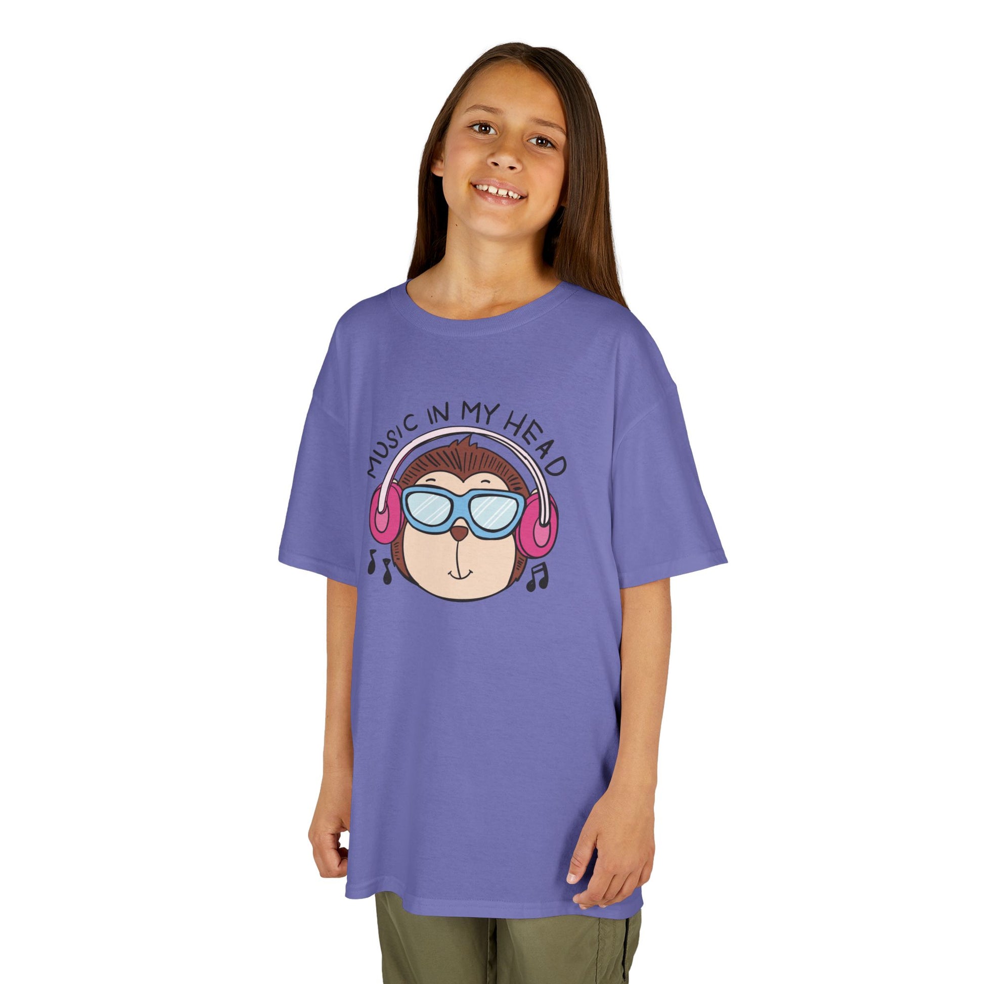 Girl wearing a purple "Music In My Head" monkey kids T-shirt with a cartoon monkey wearing headphones. Part of the Vivid Divergence Sensory Friendly Kids Shirts Range. The perfect T-shirt for sensory-sensitive kids and comes with a Sensory Satisfaction Promise.