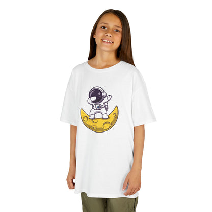 Girl wearing a white "Dabbing Astronaut on the Moon" kids T-shirt with an astronaut dabbing while sitting on a crescent moon. Part of the Vivid Divergence Sensory Friendly Kids Shirts Range. The perfect T-shirt for sensory-sensitive kids and comes with a Sensory Satisfaction Promise.
