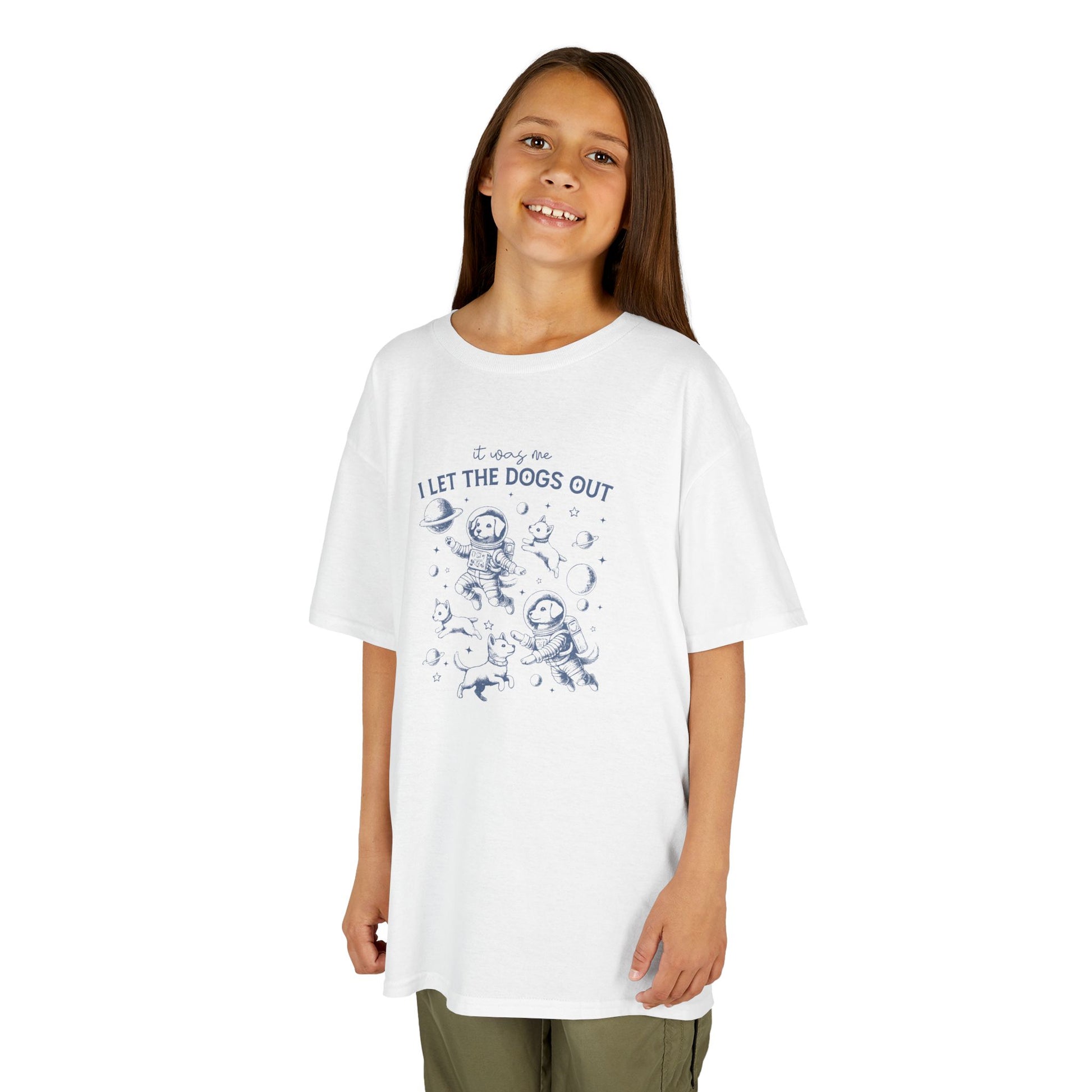 Girl wearing a white "It Was Me, I Let The Dogs Out" kids T-shirt with playful dog graphics. Part of the Vivid Divergence Sensory Friendly Kids Shirts Range. The perfect T-shirt for sensory-sensitive kids and comes with a Sensory Satisfaction Promise.