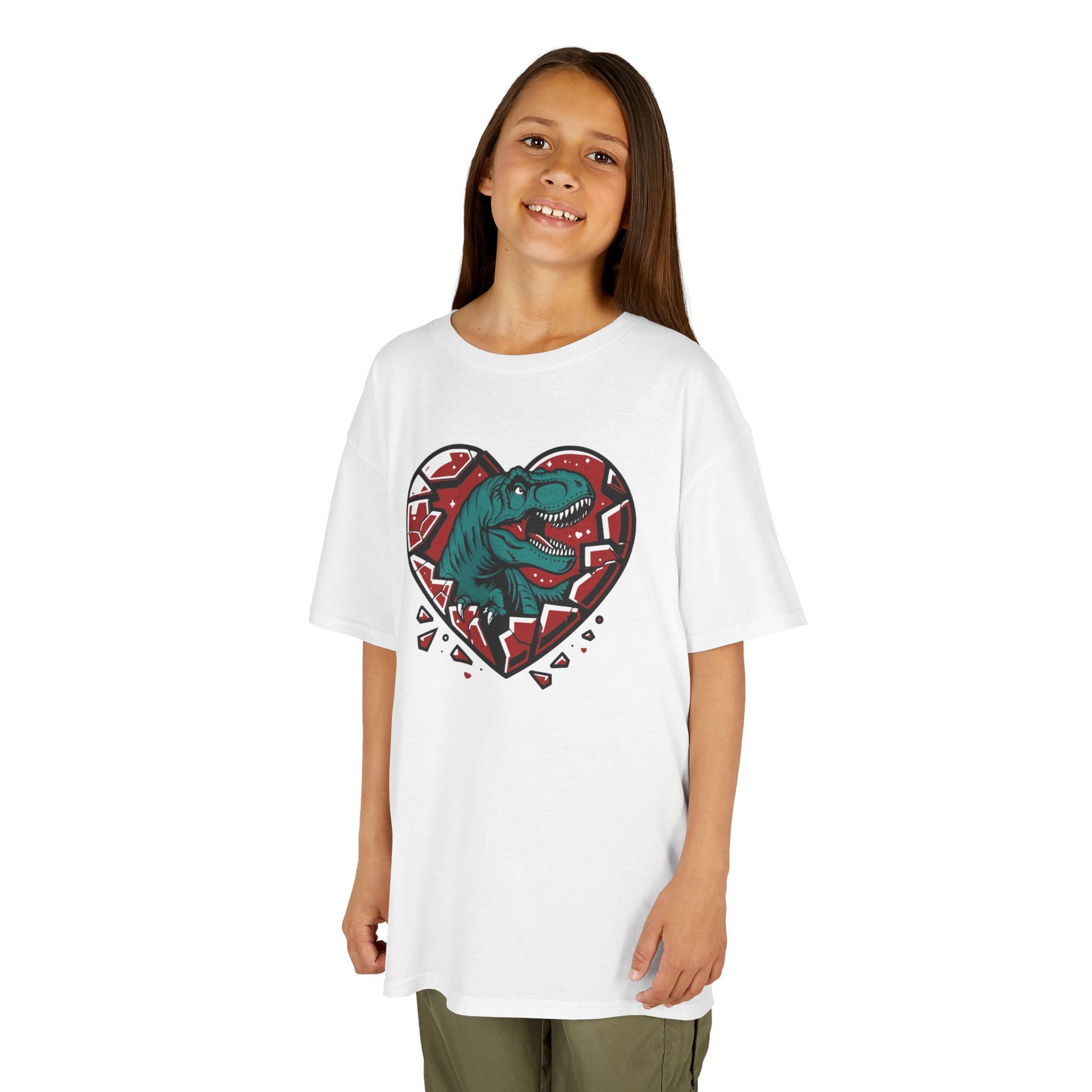 Girl wearing a white "Jurassic Heart" kids T-shirt with a dinosaur inside a heart graphic. Part of the Vivid Divergence Sensory Friendly Kids Shirts Range. The perfect T-shirt for sensory-sensitive kids and comes with a Sensory Satisfaction Promise.