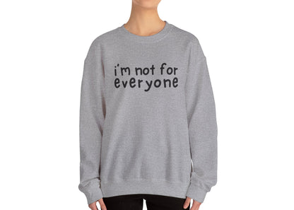 Model wearing a gray sweater jumper with the text "I'm Not For Everyone" in bold black lettering. Part of the Vivid Divergence Sensory Friendly Unisex Sweater Jumper Range.