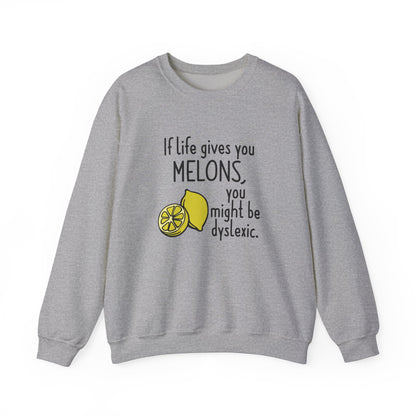 Front view of a gray sweatshirt featuring an illustration of melons and the text "If Life Gives You Melons, You Might Be Dyslexic." Part of the Vivid Divergence Sensory Friendly Unisex Sweater Jumper Range.