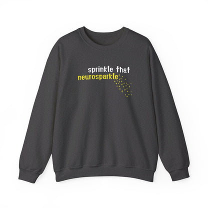 Front view of a gray sweater jumper with the text "Sprinkle That Neurosparkle" in yellow and white lettering, surrounded by sparkling star graphics. Part of the Vivid Divergence Sensory Friendly Unisex Sweater Jumper Range.